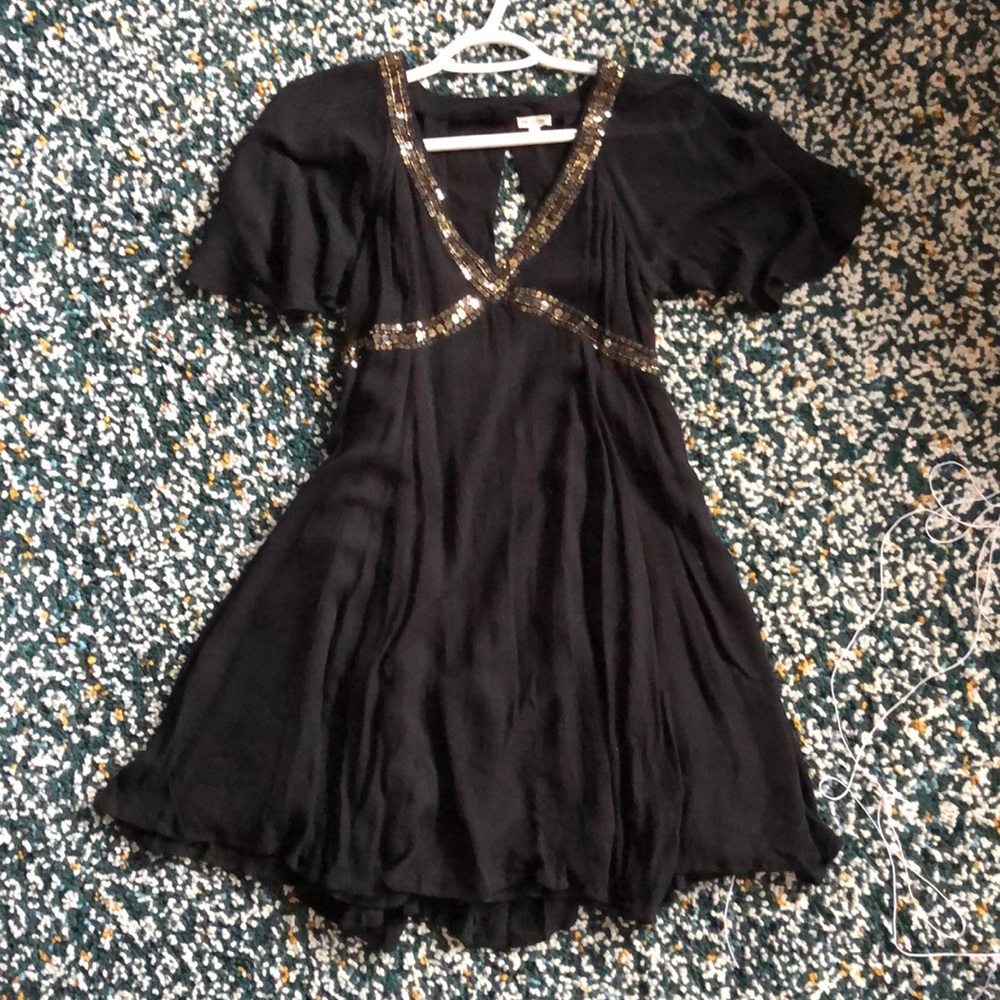 Em Creme black dress with sequence details